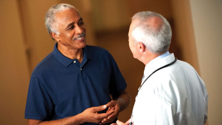 Older man talks with doctor